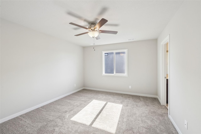 unfurnished bedroom with carpet floors, visible vents, a ceiling fan, and baseboards