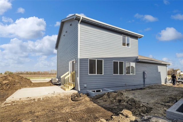 view of side of home with a patio area, entry steps, and central air condition unit