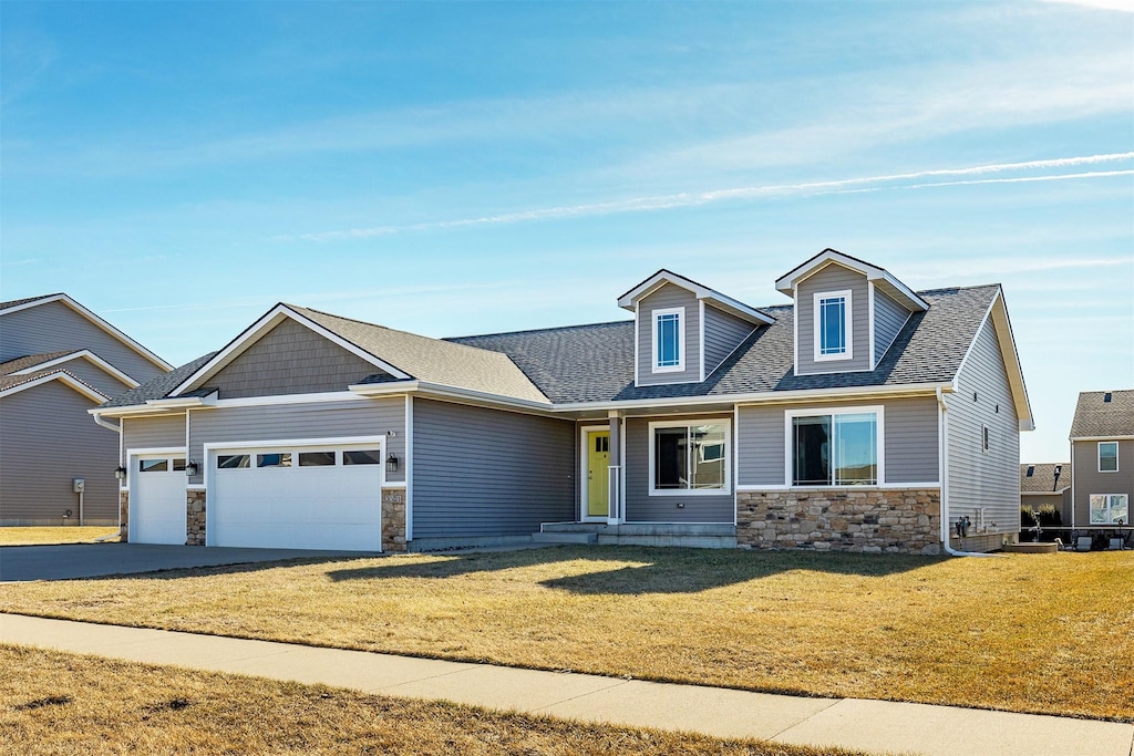 view of front facade with a garage and a front lawn