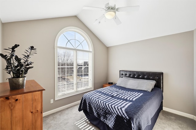 bedroom featuring ceiling fan, vaulted ceiling, and light carpet