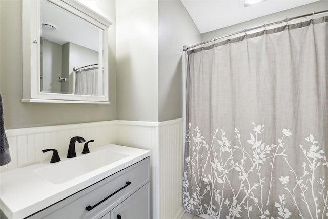 bathroom featuring walk in shower and vanity