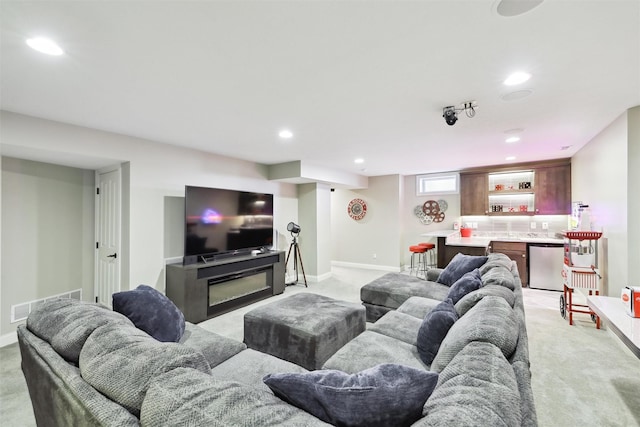 carpeted living room featuring bar area