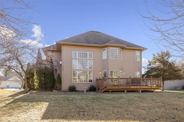 rear view of property with a wooden deck and a yard