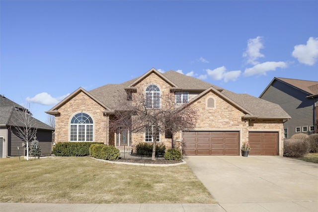 view of front property featuring a garage and a front yard