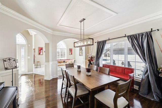 dining room with dark hardwood / wood-style flooring, a wealth of natural light, and ornamental molding