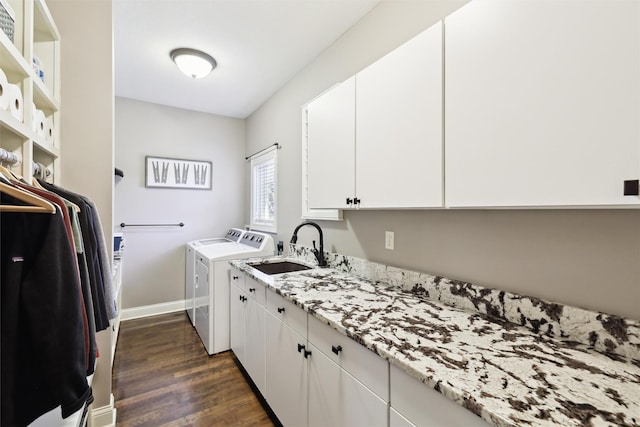 washroom featuring dark hardwood / wood-style flooring, cabinets, sink, and washer and dryer