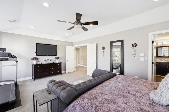 carpeted bedroom with ceiling fan and ensuite bathroom