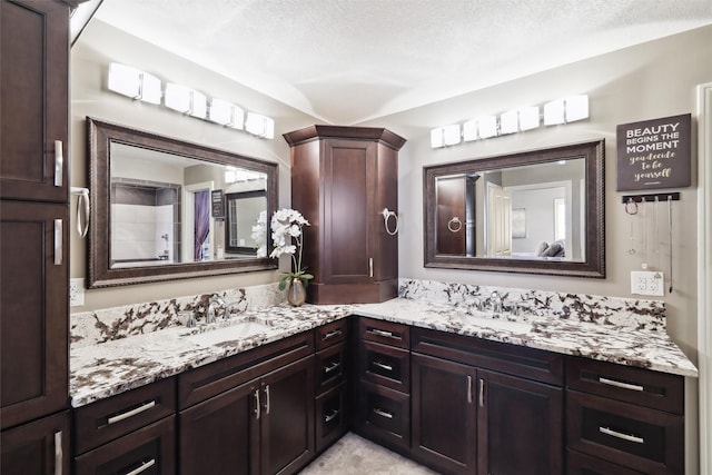 bathroom with vanity and a textured ceiling