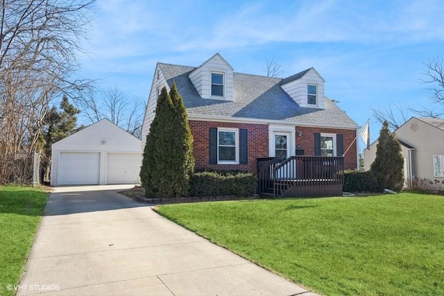 cape cod home with an outbuilding, a garage, and a front yard