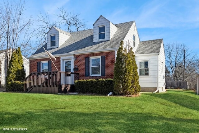 view of front of house featuring a front lawn and a deck