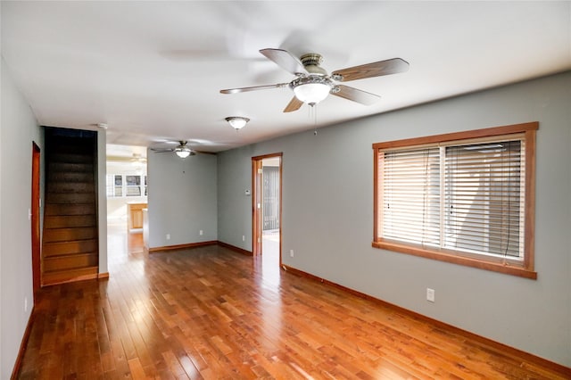 empty room with hardwood / wood-style flooring and ceiling fan