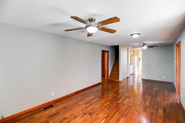 spare room with dark hardwood / wood-style floors and ceiling fan