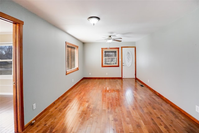 unfurnished room with wood-type flooring and ceiling fan