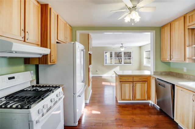 kitchen featuring dark hardwood / wood-style flooring, white range with gas cooktop, stainless steel dishwasher, kitchen peninsula, and light brown cabinets