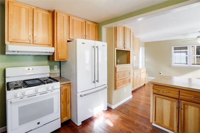 kitchen with dark wood-type flooring, white appliances, light brown cabinetry, and ceiling fan