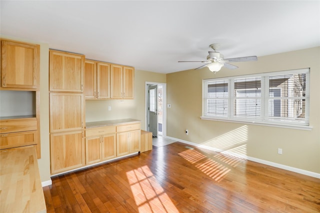 kitchen with hardwood / wood-style flooring, ceiling fan, and light brown cabinetry