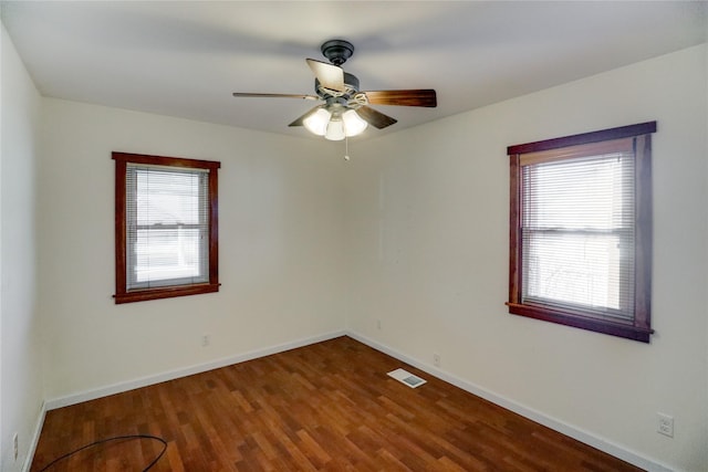 unfurnished room with hardwood / wood-style flooring, ceiling fan, and plenty of natural light