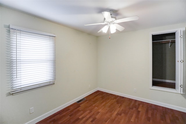 interior space featuring dark wood-type flooring and ceiling fan