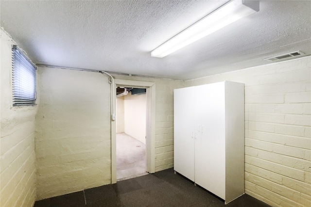 basement featuring a textured ceiling