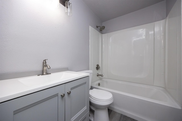 full bathroom featuring hardwood / wood-style flooring, vanity, toilet, and shower / bathing tub combination