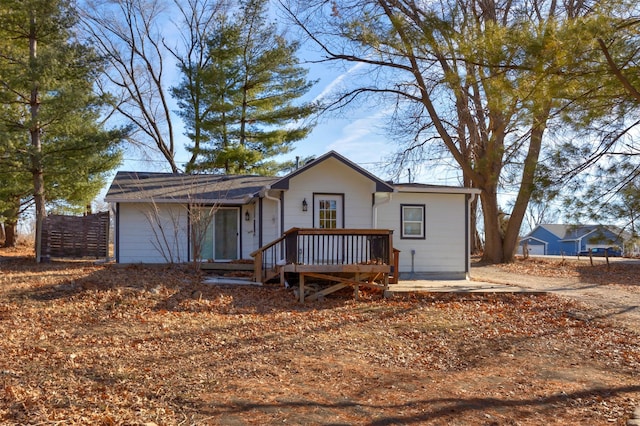 rear view of house featuring a wooden deck