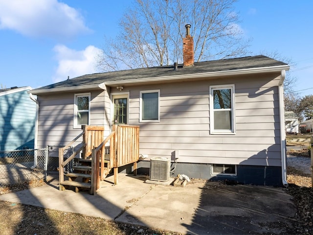 rear view of property featuring cooling unit and a patio area