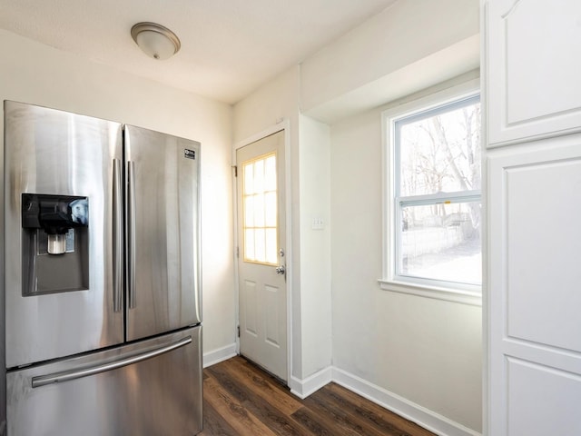 kitchen featuring white cabinets, dark hardwood / wood-style flooring, and stainless steel fridge with ice dispenser