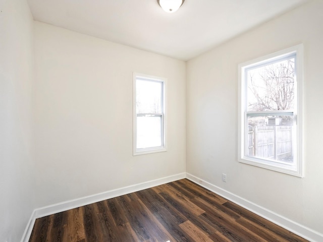 spare room featuring dark wood-type flooring