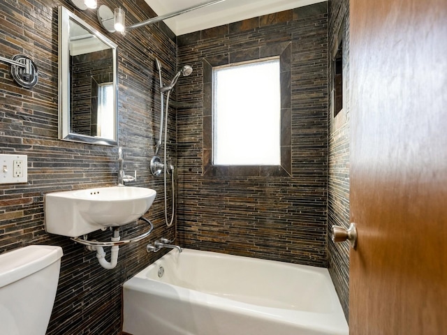 full bathroom with tiled shower / bath, toilet, and sink