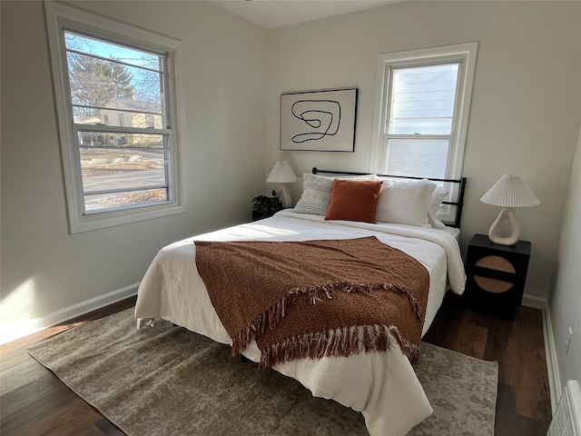 bedroom with wood-type flooring and multiple windows