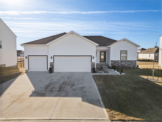 single story home featuring a garage and a front lawn