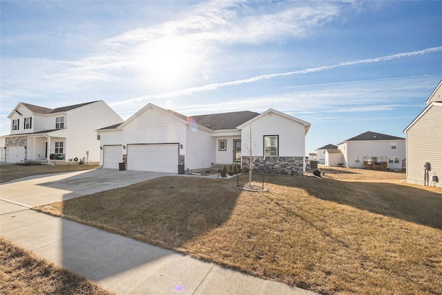 view of front of home featuring a garage and a front lawn