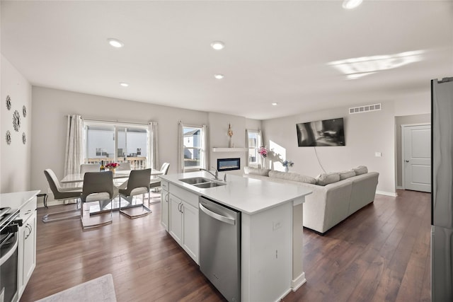 kitchen with sink, dark wood-type flooring, dishwasher, a kitchen island with sink, and white cabinets