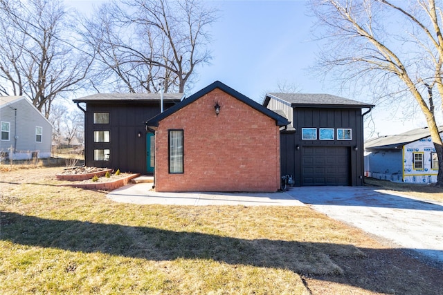 rear view of house with a yard and a garage