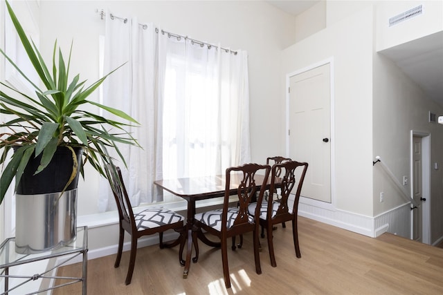 dining area with light hardwood / wood-style floors