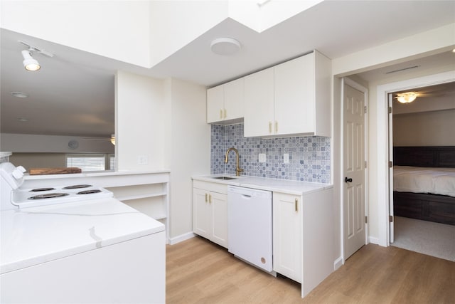 kitchen featuring white cabinetry, sink, light hardwood / wood-style floors, and dishwasher