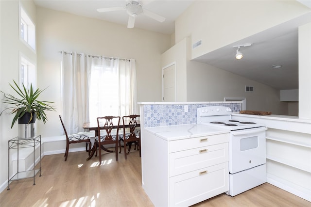 kitchen featuring ceiling fan, white cabinetry, vaulted ceiling, white electric stove, and light wood-type flooring