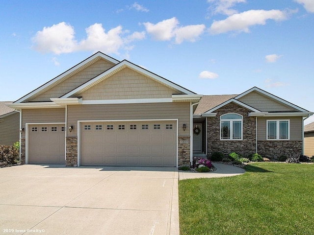 craftsman house with a garage and a front lawn