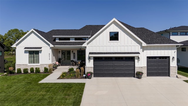 modern inspired farmhouse featuring a garage and a front yard