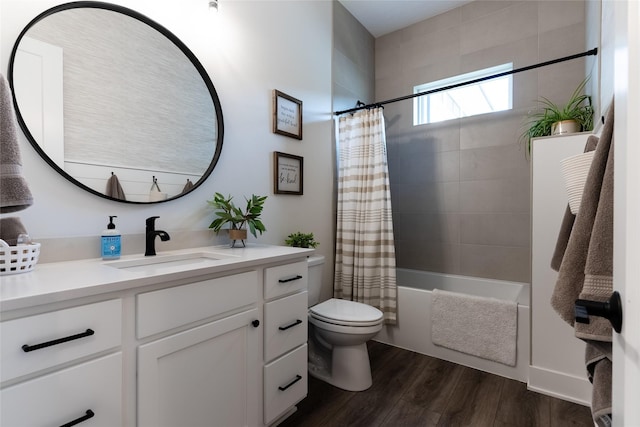 full bathroom with vanity, hardwood / wood-style floors, toilet, and shower / bath combo