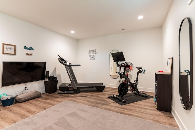 workout room with light wood-type flooring