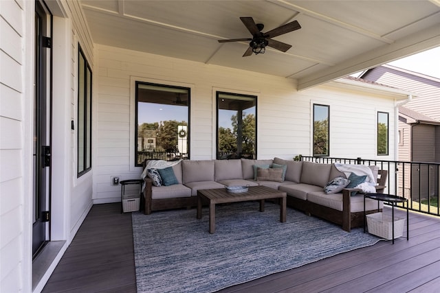 wooden deck featuring outdoor lounge area and ceiling fan