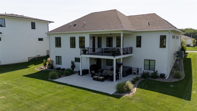 back of property with central AC, a balcony, a patio area, and a lawn