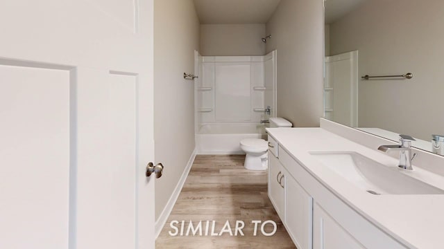 full bathroom with shower / bathing tub combination, vanity, wood-type flooring, and toilet