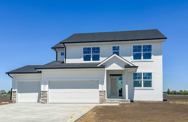 view of front of house with driveway, stone siding, cooling unit, and roof with shingles