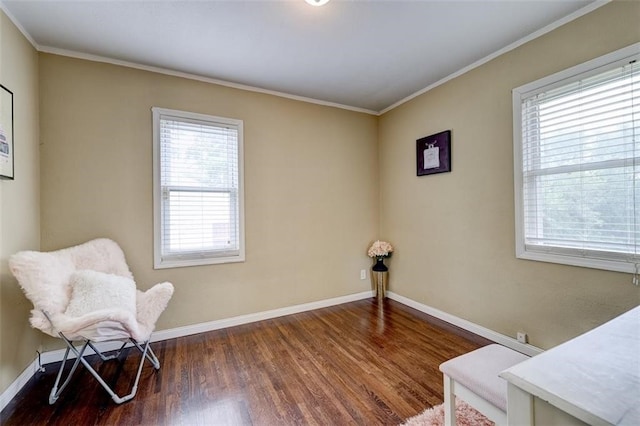 living area featuring crown molding and dark hardwood / wood-style flooring