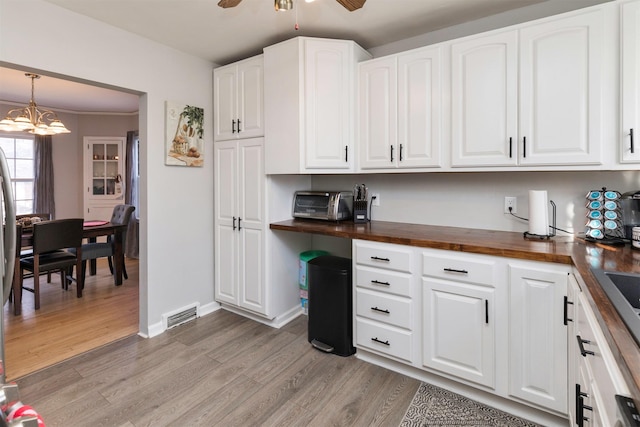 kitchen with white cabinetry and wooden counters