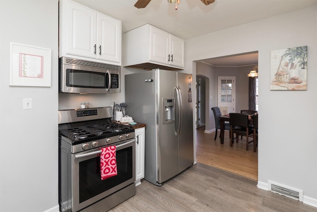 kitchen featuring white cabinetry, light hardwood / wood-style flooring, ceiling fan, and appliances with stainless steel finishes