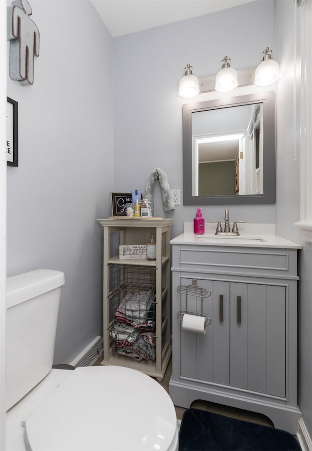 bathroom featuring vanity and toilet