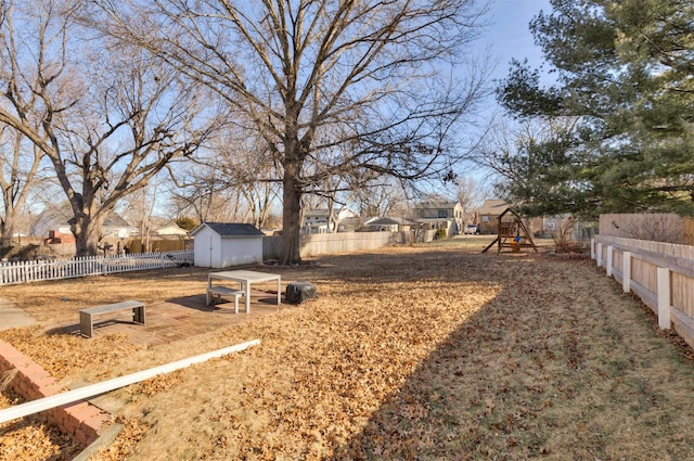 view of yard featuring a storage shed and a playground